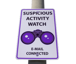 Sign-on-a-post-saying-suspicious-activity-watch-email-connected-with-binoculars